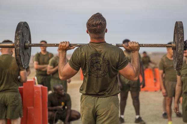 Athlete performing military-inspired strength training in a gym